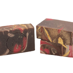 Two bars of Molly's Apothecary Bar Soap with a Frosted Winterberry pattern, featuring dark and light chocolate colors with red and gold accents. Available at Be Charmed