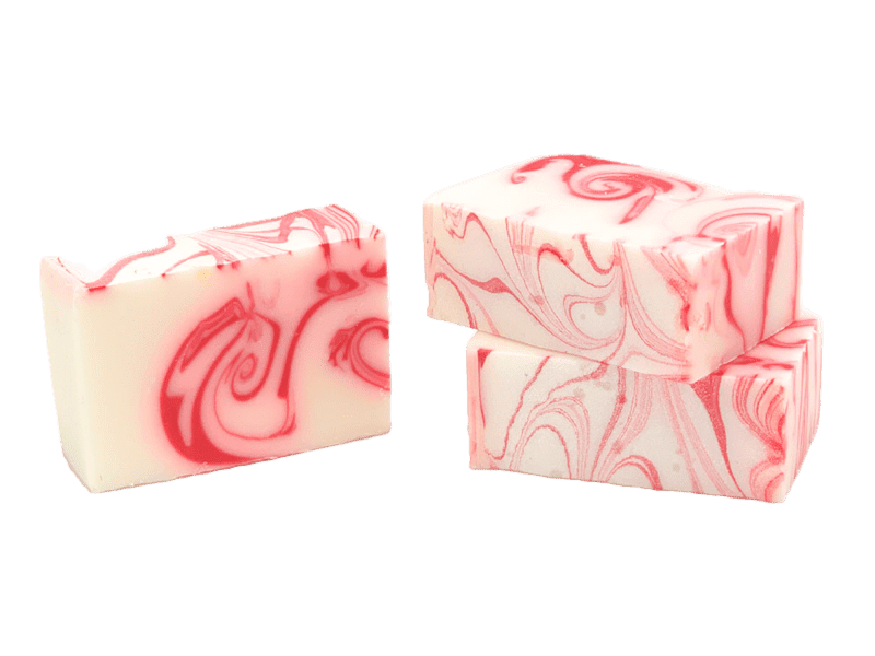 Two bars of handmade soap with a peppermint pattern in red and white colors. Available at Be Charmed