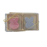 A pack of two bunny-shaped gumdrop Soap in a transparent container with a gold-colored lid. One gumdrop is pink and the other is blue. Available at Be Charmed