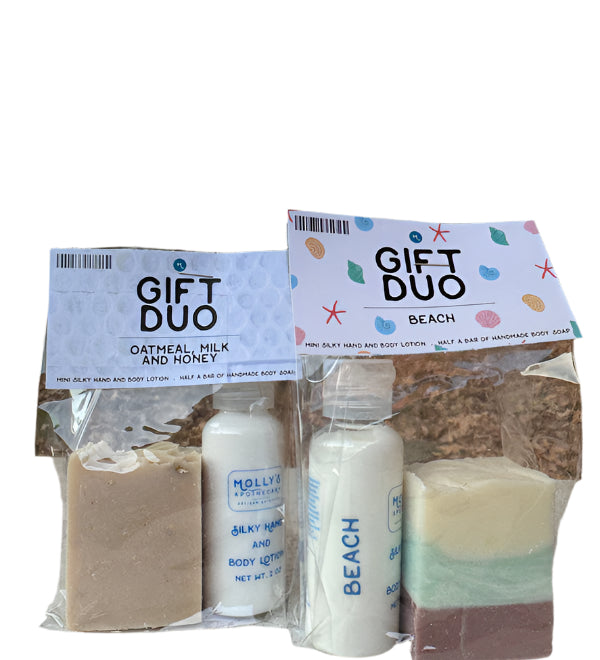 A gift duo set from Molly's Apothecary, including a bar of soap and a bottle of lotion, packaged in a clear plastic bag with a printed label that says 'GIFT DUO' and 'DATHEAL PICKLING RECIPE'. The products are visible through the transparent packaging. Available at Be Charmed