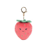 Strawberry-shaped keychain with a smiling face on a white background. Available at Be Charmed