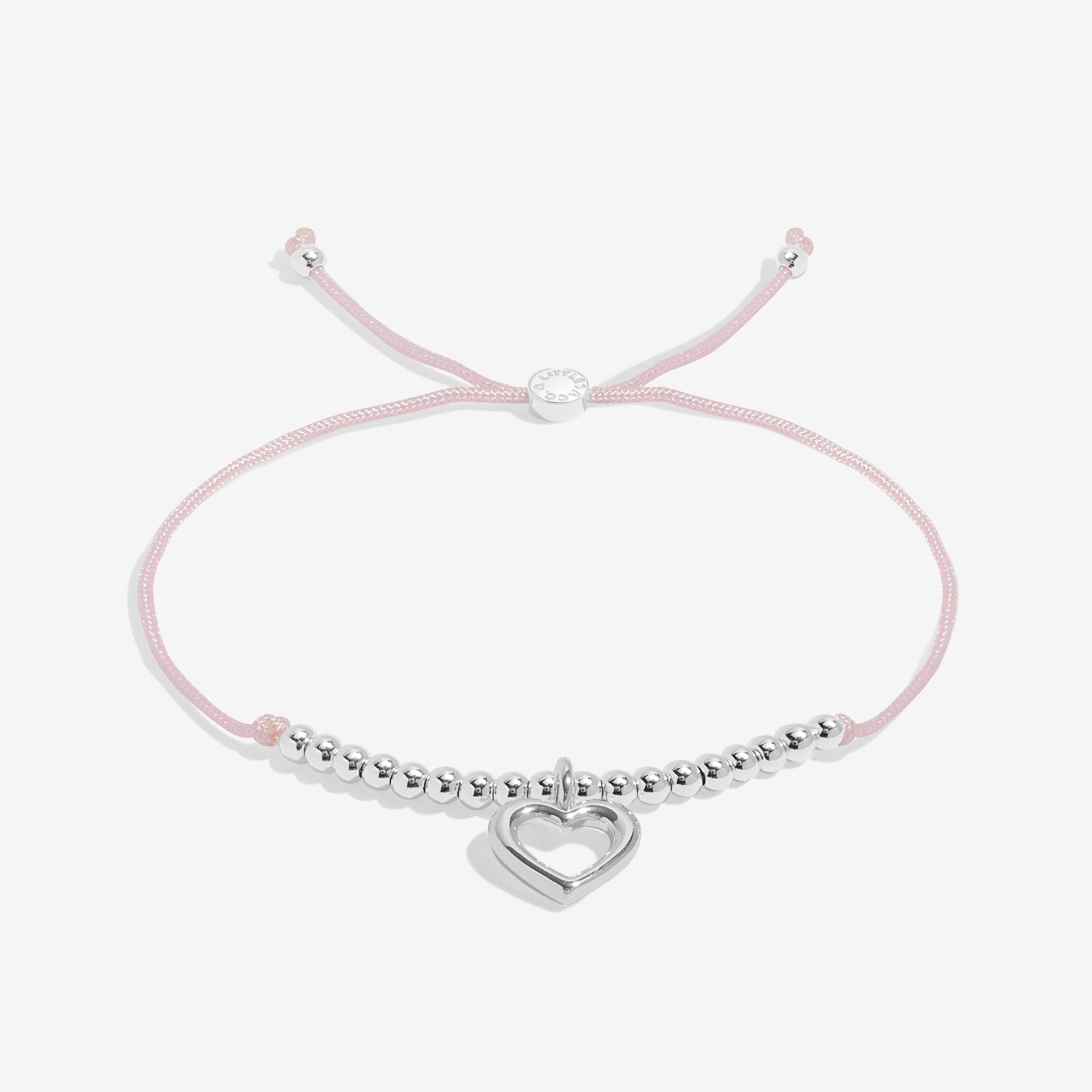 Pink bracelet with a silver heart charm on a white background. Available at Be Charmed