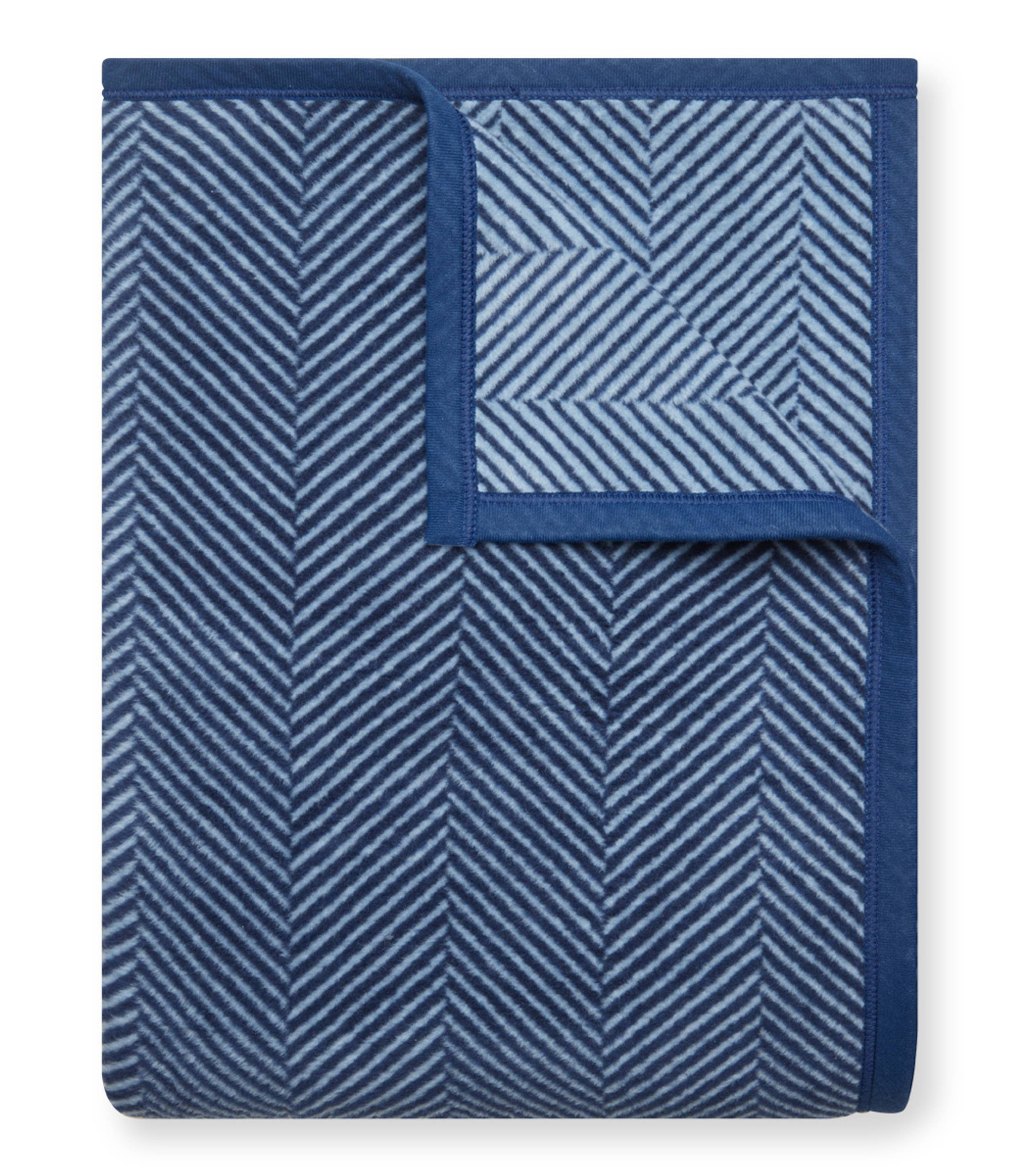 Navy Chappy Wrap Harborview Herringbone Blanket – Original size throw in a classic light grey herringbone pattern. Plush, durable, and machine washable. A cozy neutral accent for the home or perfect gift. Available at Be Charmed.