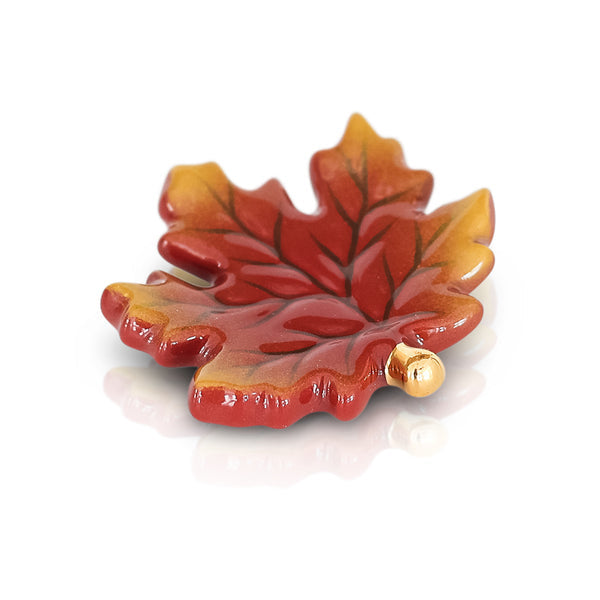 A small, red and brown leaf-shaped Nora Fleming mini charm. Available at Be Charmed