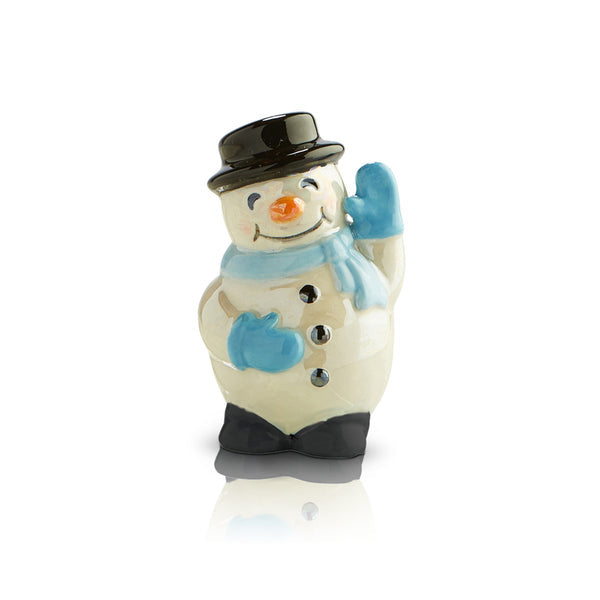 A ceramic snowman mini figurine with a smiling face, blue scarf, and black hat, standing on a beige base. Available at Be Charmed