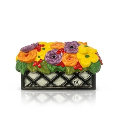 A colorful floral-patterned Nora Fleming mini charm. Available at Be Charmed