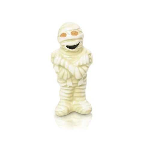 A beige-colored mini mummy-shaped charm with a smiling face. Available at Be Charmed