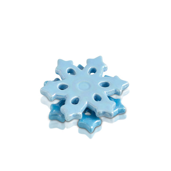A blue snowflake-shaped charm with a central hole for hanging. Available at Be Charmed