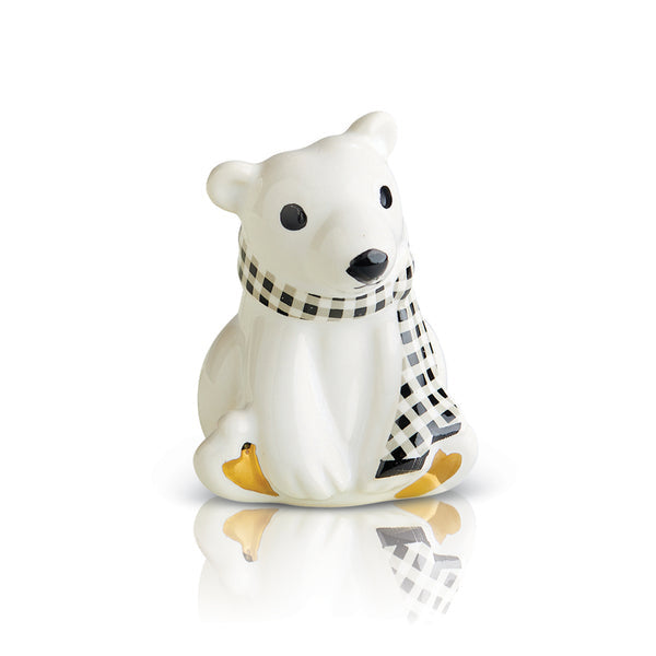 A mini figurine of a polar bear wearing a black and white checkered scarf, sitting on a white base that resembles a frosty surface. Available at Be Charmed