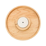 A Nora Fleming wooden round cracker tray with a central circular depression, made of maple wood, displayed against a white background. Available at Be Charmed