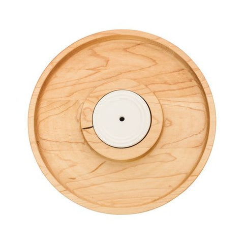 A Nora Fleming wooden round cracker tray with a central circular depression, made of maple wood, displayed against a white background. Available at Be Charmed