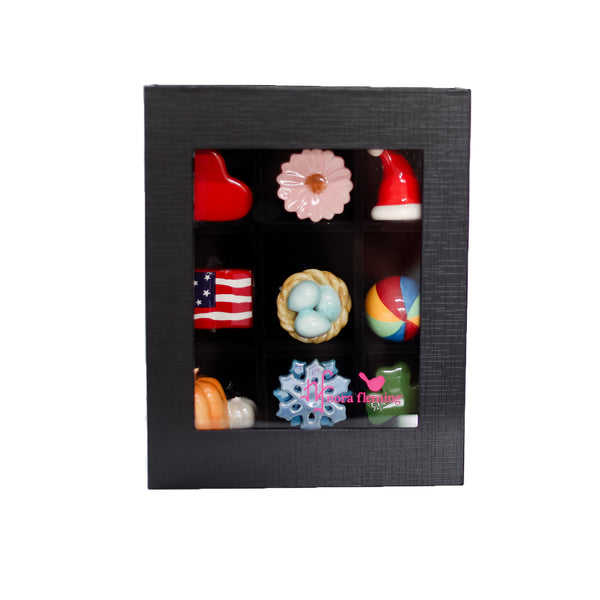 Set of small Nora Fleming minis s in a black box on a white background. Available at Be Charmed
