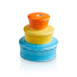 A multicolored birthday cake mini charm made of glass with a candle on top, resembling a tiered birthday cake with colorful layers. Available at Be Charmed