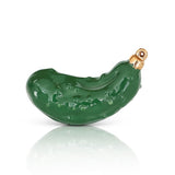 This image features a charming Nora Fleming mini charm, designed to add a festive touch to your holiday decor. The charm is shaped like a glossy, pickle-green pickle, with a textured surface that mimics the look of a real pickle. Available at Be Charmed