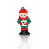 A Nora Fleming mini of a Christmas caroler in a green and red outfit, holding a holly branch, with a white background. Available at Be Charmed