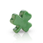 A small, green shamrock-shaped dish charm. Available at Be Charmed