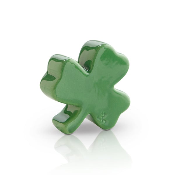 A small, green shamrock-shaped dish charm. Available at Be Charmed