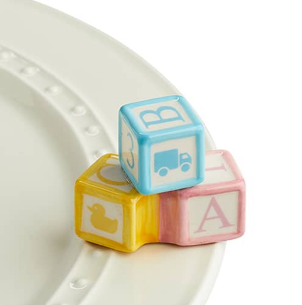 Nora Fleming “Ohhh, Baby!” Mini accent featuring an adorable baby-themed design for trays, platters, and celebrations. Available at Be Charmed