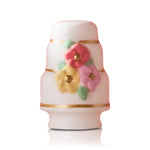 Decorative ceramic cake Nora Fleming mini with floral designs on a white background. Available at Be Charmed