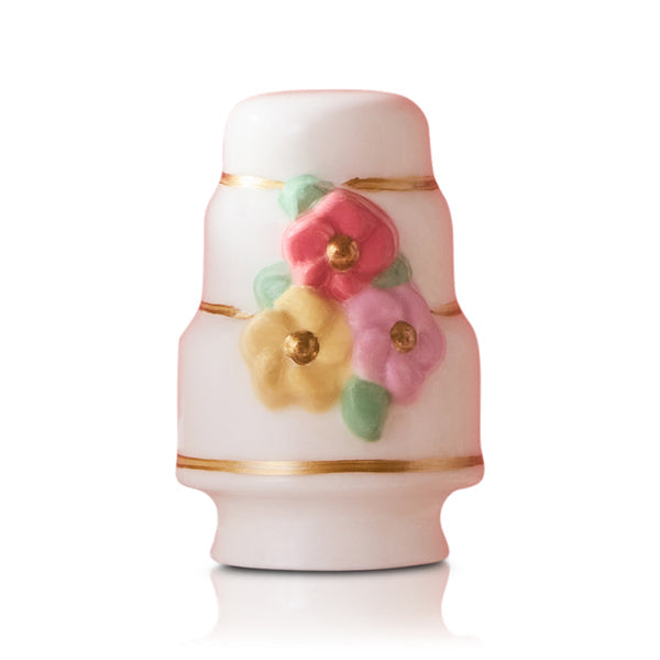Decorative ceramic cake Nora Fleming mini with floral designs on a white background. Available at Be Charmed