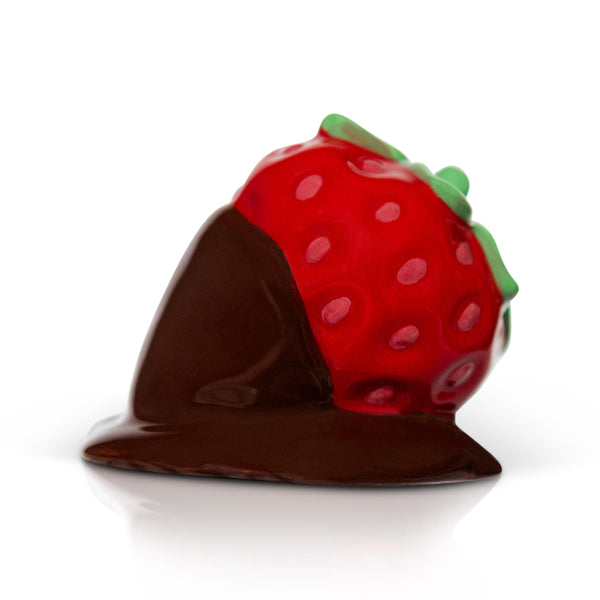 A chocolate-covered strawberryNora Fleming Mini with red and green details on a white background. Available at Be Charmed