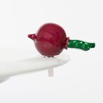 A red and green Nora Fleming Totally Rad radish mini figurine with a clip attached to its stem. Available at Be Charmed
