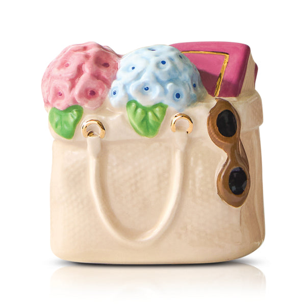 Decorative ceramic handbag with floral designs Nora Fleming Mini on a white background. Available at Be Charmed