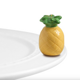 A miniature pineapple-shaped dish charm placed on a white plate against a white background. Available at Be Charmed