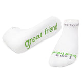 A pair of white crew socks with the phrase 'great friend' printed in green text across the top. Available at Be Charmed