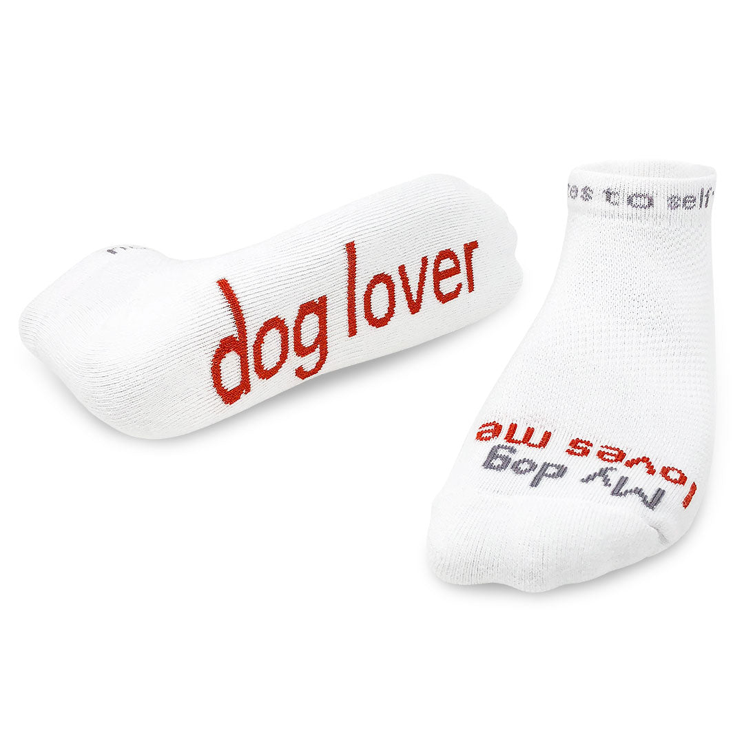 A pair of white crew socks with the words 'dog lover' and 'My dog loves me' printed in red. Available at Be Charmed