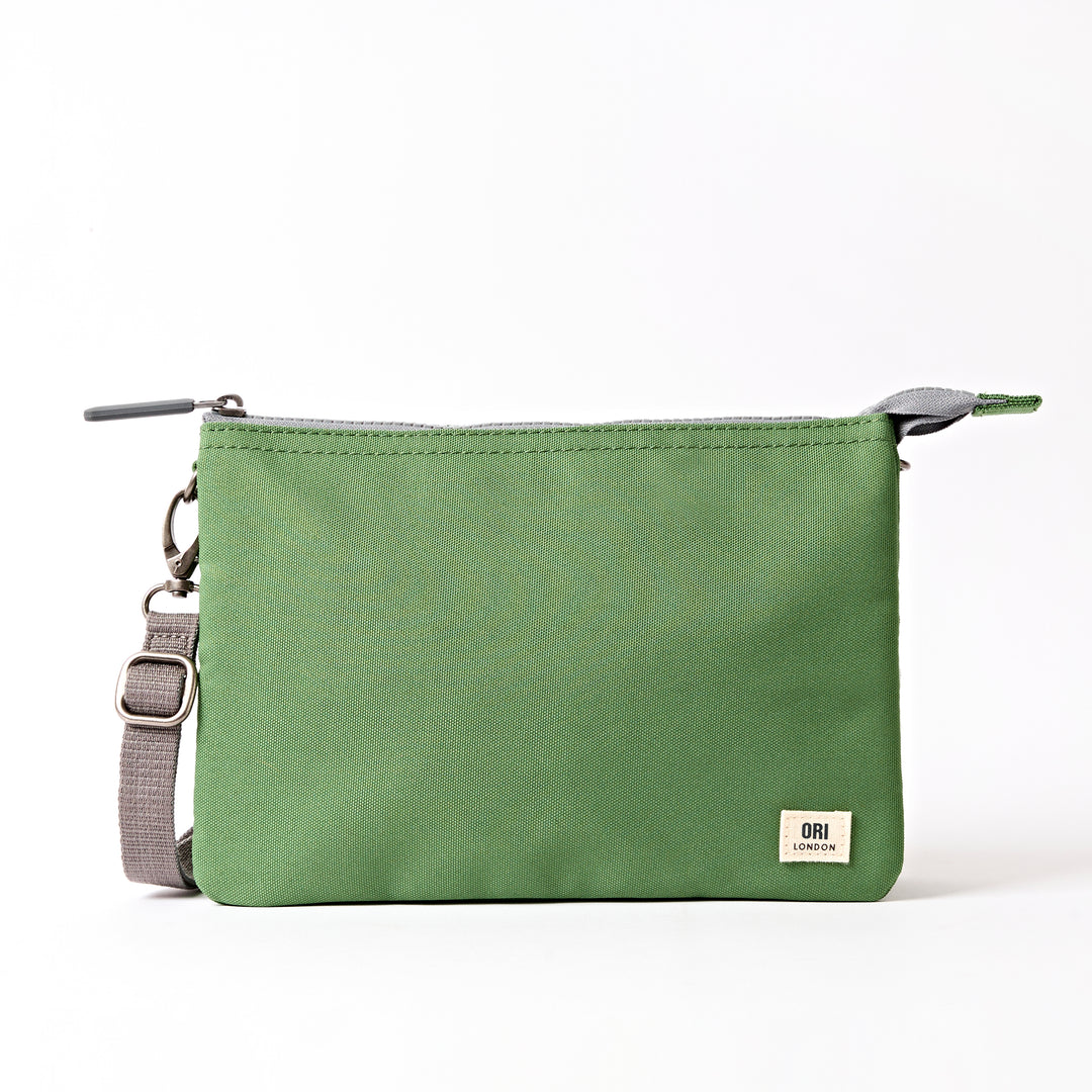 A lightweight and sustainable Artichoke Ori Carnaby Crossbody bag featuring three secure interior compartments, available at Be Charmed.