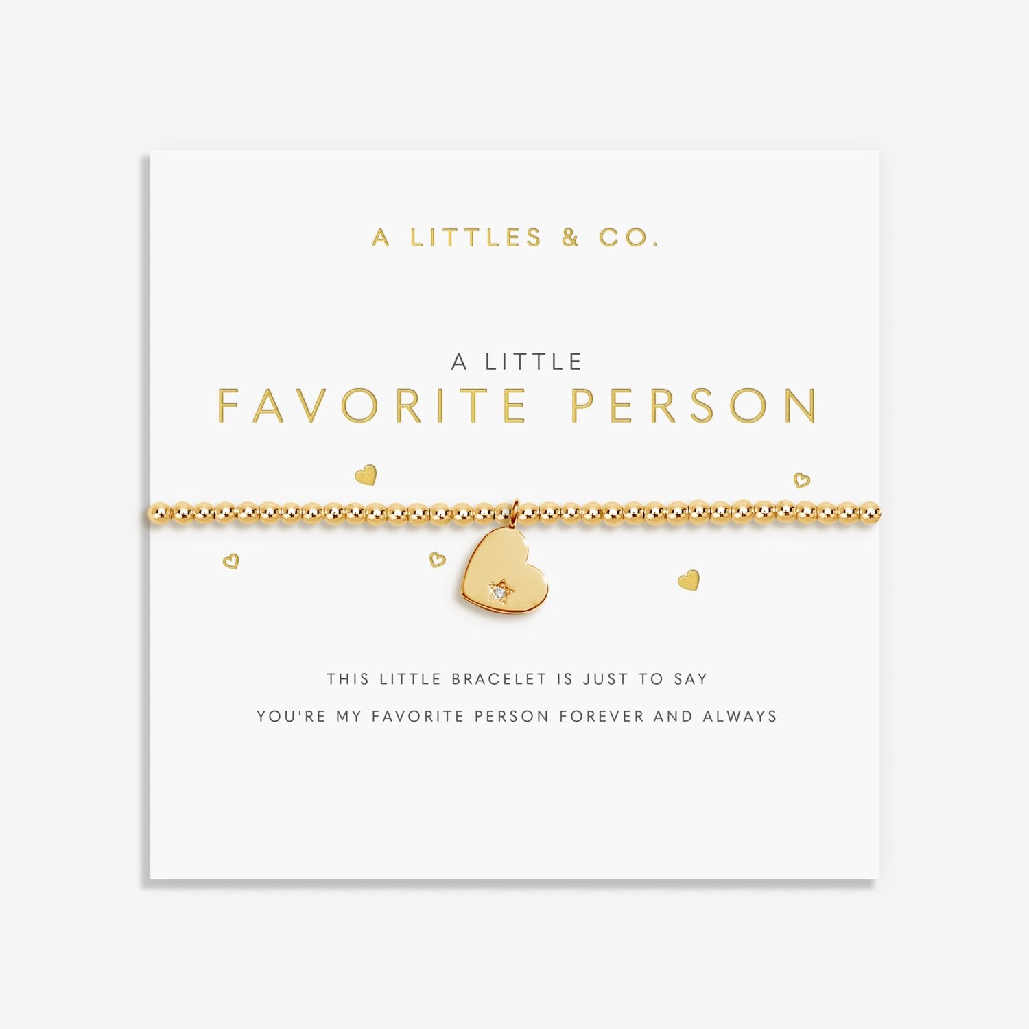 Gold bracelet with heart charm on a white card from A Littles & Co. 