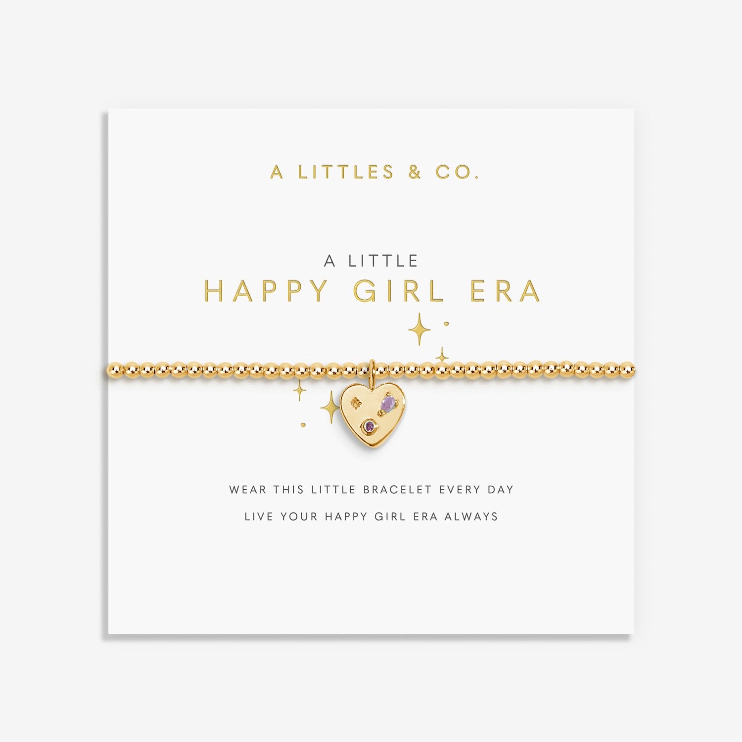 Gold bracelet with heart charm on a white card with 'A Littles & Co.' text. Available at Be Charmed