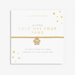 Gold bracelet with paw charm on a white card with text. Available at Be Charmed