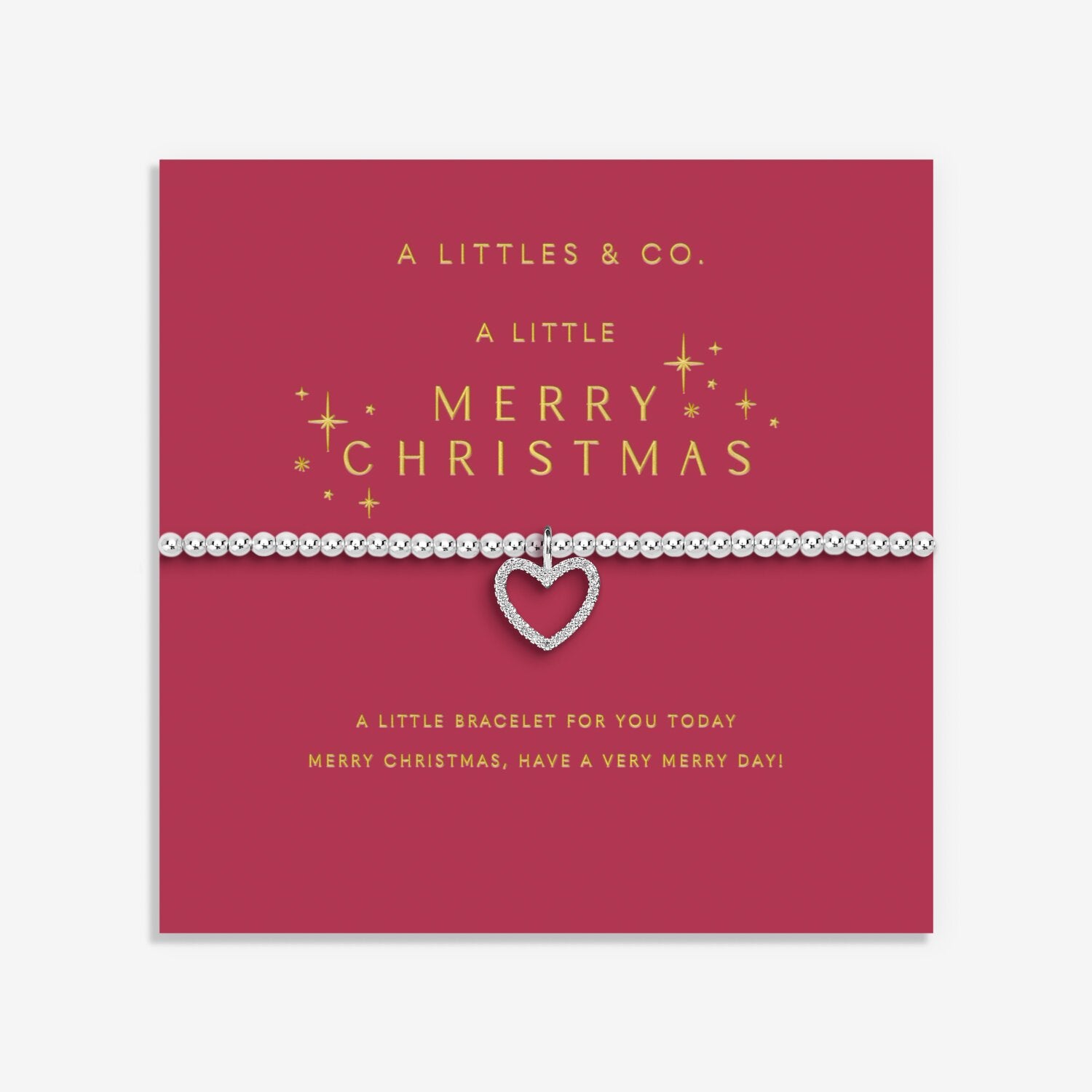 Silver bracelet with a heart charm on a red card with gold text, featuring 'A Littles & Co.' branding. Available at Be Charmed