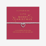Silver bracelet with a heart charm on a red card with gold text, featuring 'A Littles & Co.' branding. Available at Be Charmed