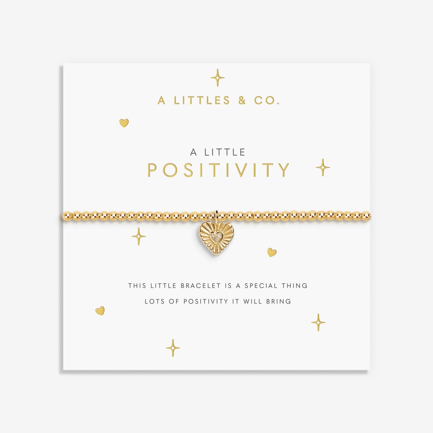 Gold bracelet with heart charm on a 'A Littles & Co.' branded card. Available at Be Charmed