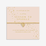 Gold heart bracelet on a pink card with 'A Littles & Co.' branding. Available at Be Charmed