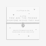 Silver bracelet with heart charm on a white card with text. Available at Be Charmed