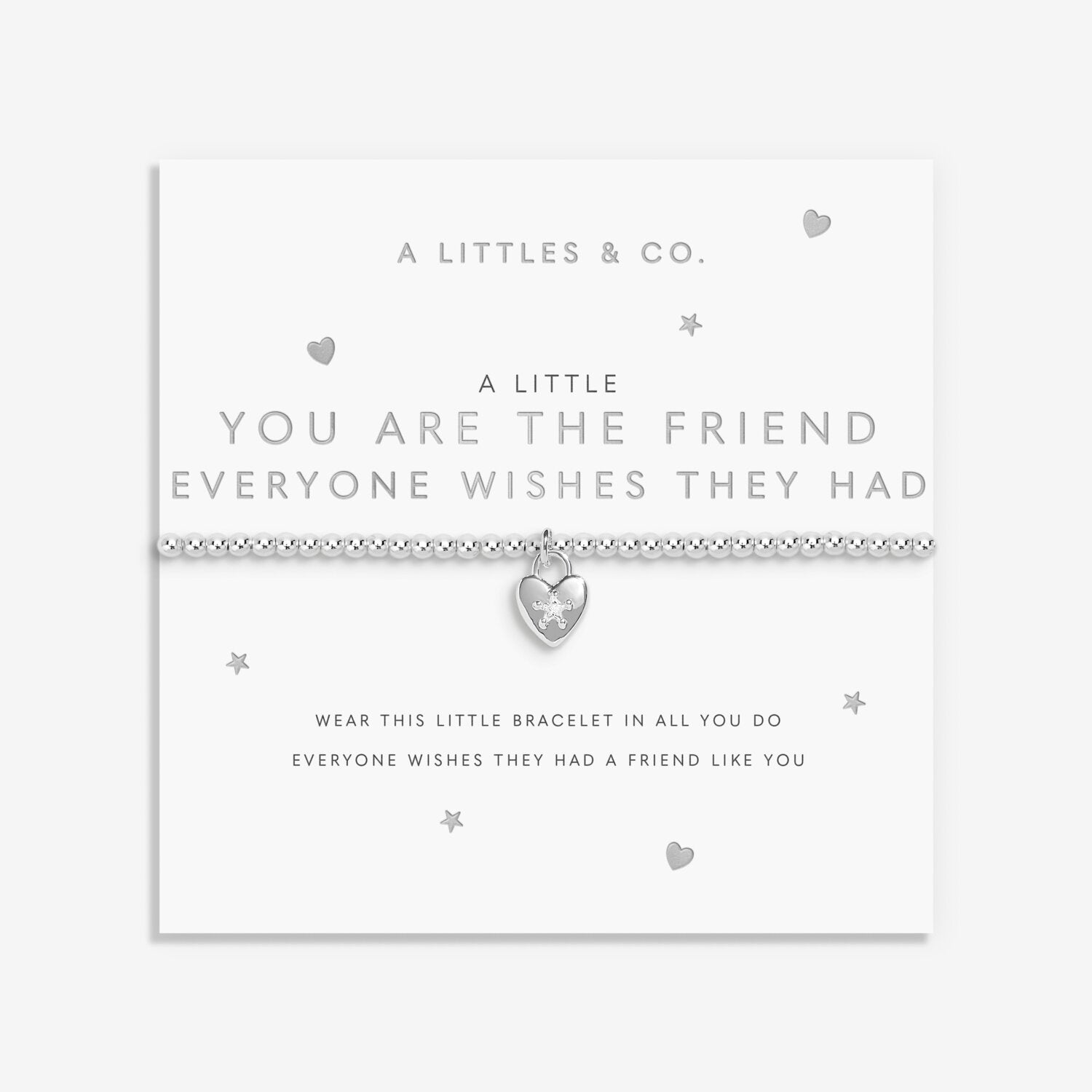 Silver bracelet with heart charm on a white card with text. Available at Be Charmed