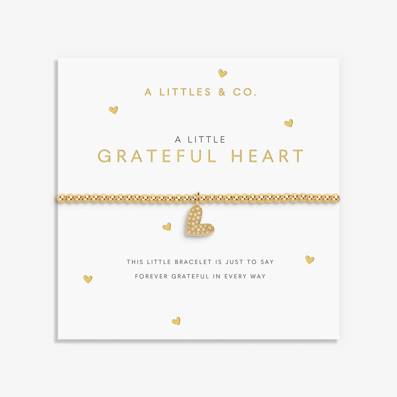 Gold bracelet with heart charm on a white card with 'A Littles & Co.' branding. Available at Be Charmed