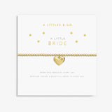 Gold heart-shaped bracelet on a card with 'A Littles & Co.' branding. Available at Be Charmed