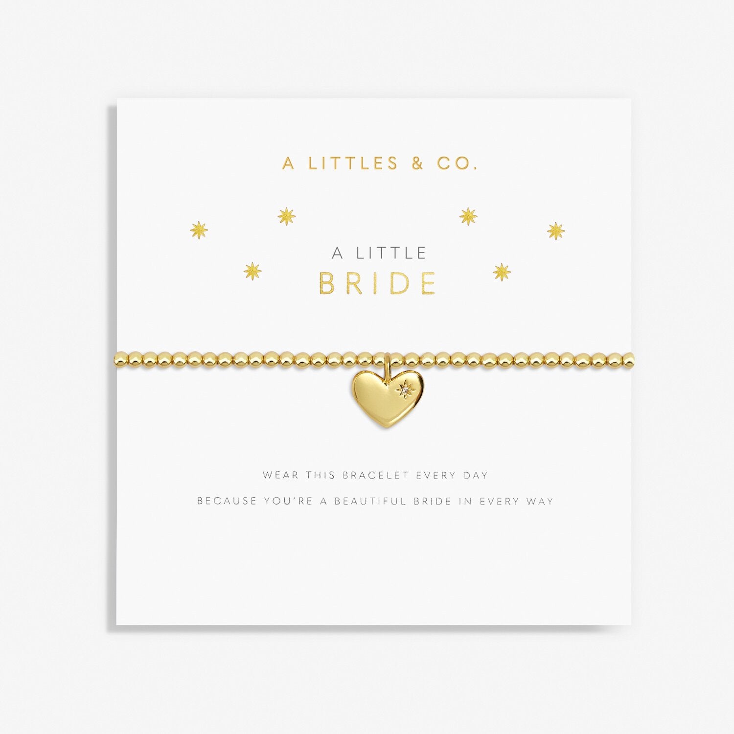 Gold heart-shaped bracelet on a card with 'A Littles & Co.' branding. Available at Be Charmed