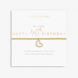 Gold heart bracelet on a white card with 'A Littles & Co' text. Available at Be Charmed