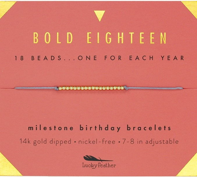 An 18-inch gold-dipped milestone birthday bracelet with a mix of beads, advertised by Lucky Feather, displayed against a red background with text detailing the product features. Available at Be Charmed