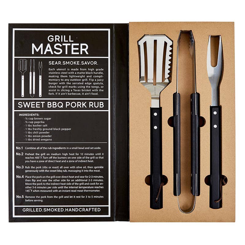 Open Box of Creative Brands BBQ Tools Book Set with stainless steel spatula, tongs & fork in masculine book-style box, includes smokey recipe—Available at Be Charmed