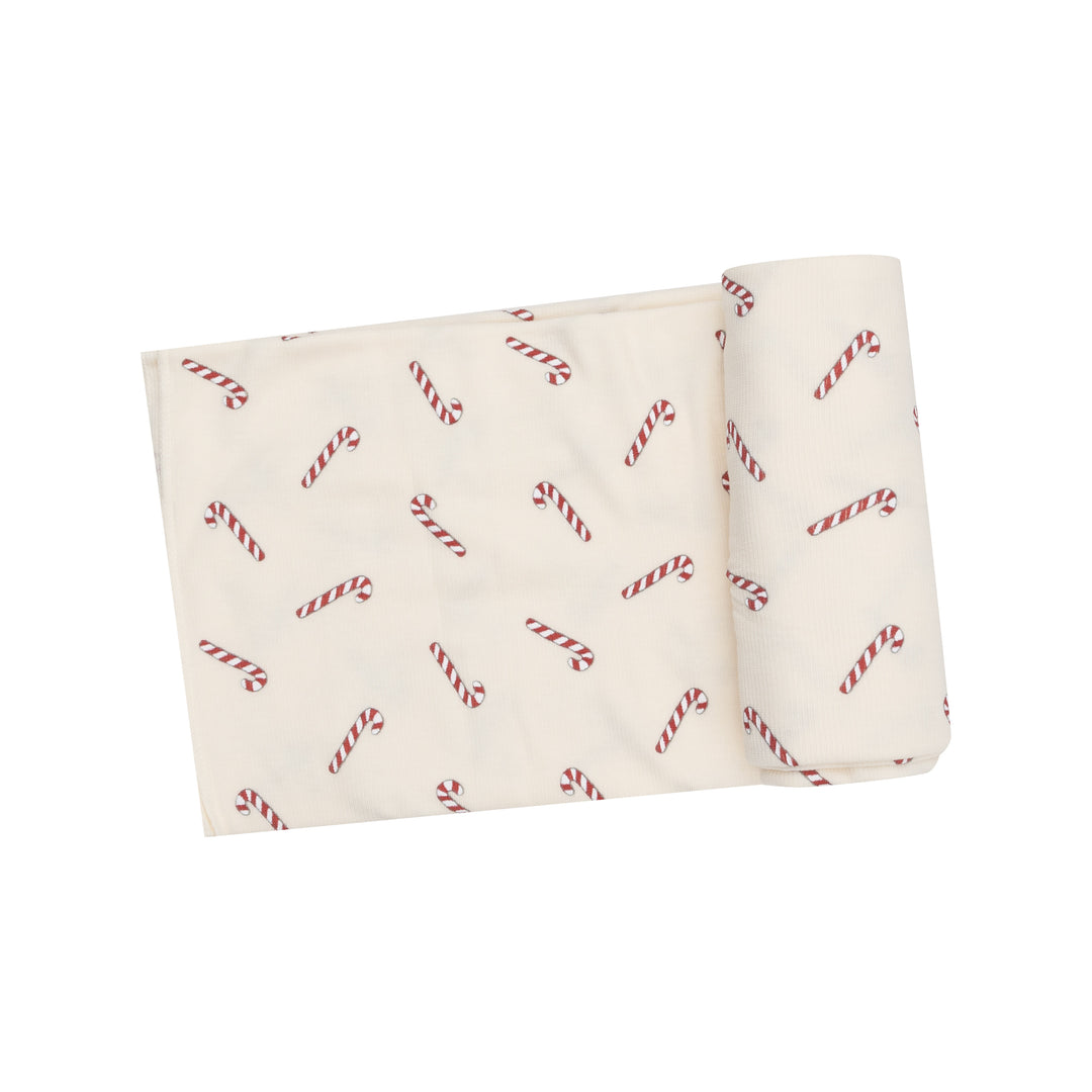 Opened Angel Dear Candy Canes Rib Swaddle Blanket for babies, featuring a festive candy cane print and soft materials, available at Be Charmed.