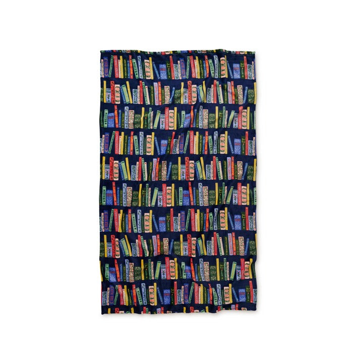 Opened fleece blanket with bookshelf pattern on a white background
