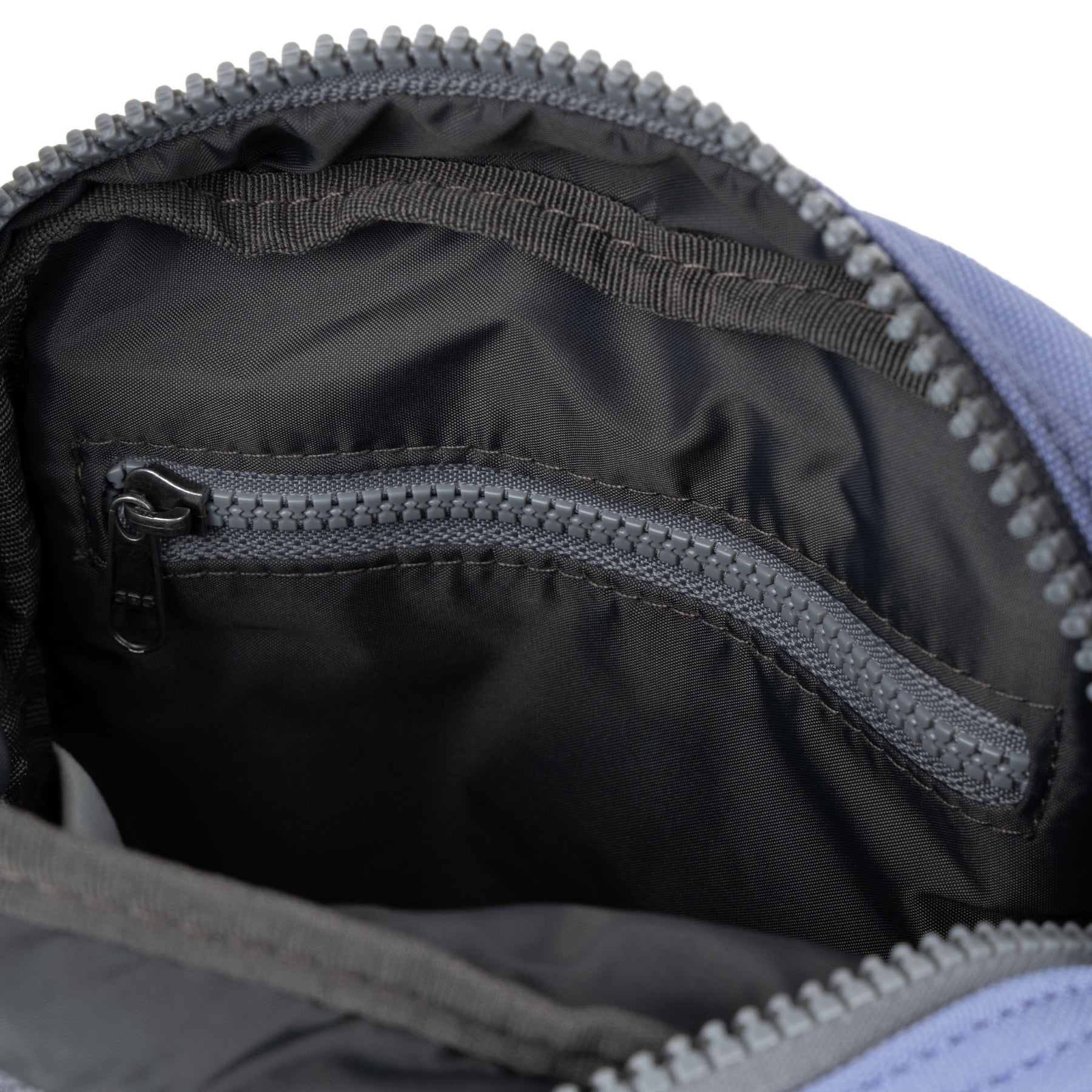 A compact and lightweight weather-resistant Ori Bond Pocket Crossbody Bag with functional zip pockets, available at Be Charmed.