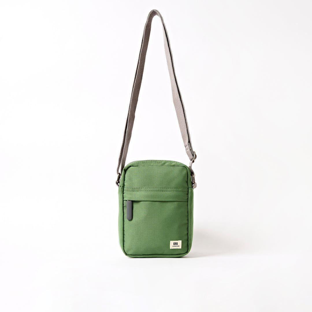 A compact and lightweight weather-resistant artichoke Ori Bond Pocket Crossbody Bag with functional zip pockets, available at Be Charmed.